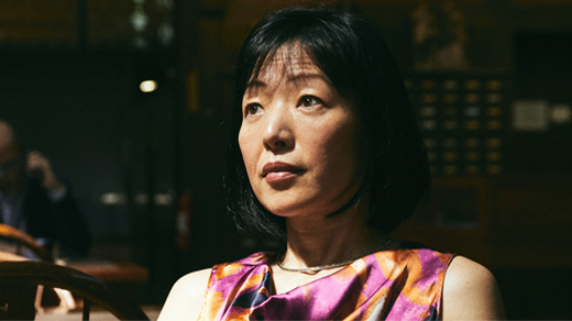 Closeup of Akiko Iwasaki of the Yale School of Medicine against a dark background.